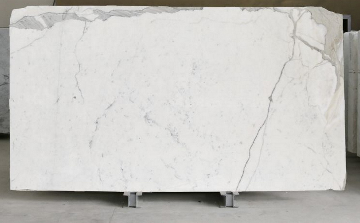 Statuario marble slab: bright pure white background with bold, dramatic grey veining — premium Italian marble